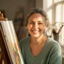 Ateliera Studio painting instructor smiling beside a sunlit easel in the Dublin studio